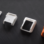 weiße 3D-gedruckte Teile und orangefarbenes Endprodukt