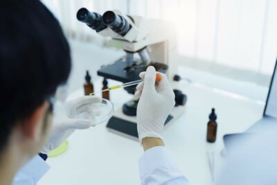 Forscher an einem Mikroskop entwickelt künstliches Augenlid aus dem 3D-Drucker für chirurgische Ausbildung in Innsbruck Wissenschaftler prüft 3D-gedrucktes künstliches Augenlid für medizinische Trainingszwecke an der Medizinischen Universität Innsbruck