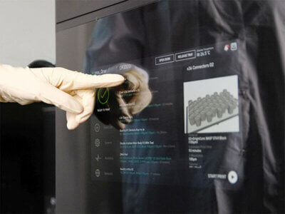 Bediener stellt Druckparameter für Stratasys-3D-Drucker ein, basierend auf der OpenAM™-Strategie. Nahaufnahme eines Bedieners, der die Druckparameter eines Stratasys-3D-Druckers an einem Touchscreen einstellt.