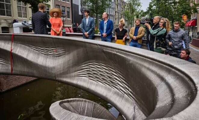 3D-gedruckte Metallbrücke von MX3D, eröffnet von Königin Máxima, mit Beteiligten und Zuschauern in Amsterdam