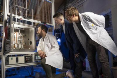 Materialprüfung für den 3D-Druck im All an der University of Glasgow im NextSpace Testrig Drei Wissenschaftler der University of Glasgow begutachten eine Materialtestkammer zur Simulation von Weltraumbedingungen für den 3D-Druck