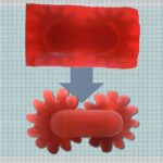 Zwei miteinander verbundene rote Zahnräder, 3D-gedruckt mit dem neuen Harz vom MIT, das durch Licht selektiv löslich oder stabil wird